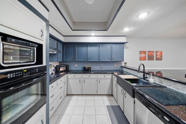 kitchen with white cabinetry, light tile patterned flooring, a raised ceiling, and blue cabinetry