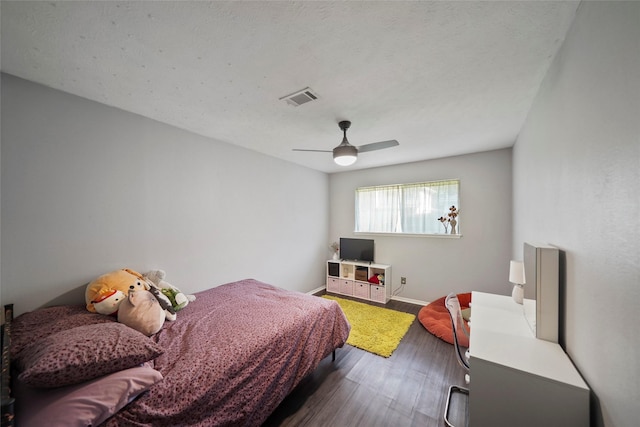 bedroom featuring ceiling fan and dark hardwood / wood-style flooring