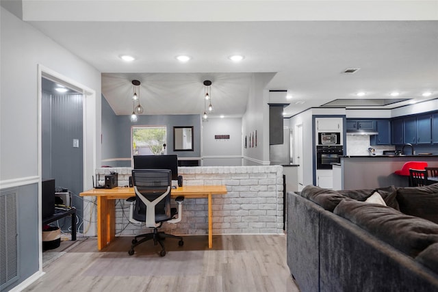 office space with sink and light wood-type flooring