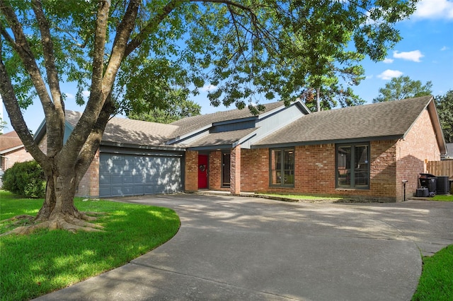 ranch-style house featuring cooling unit and a garage