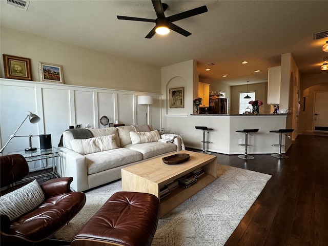 living room featuring hardwood / wood-style flooring and ceiling fan