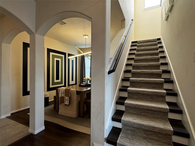 stairs featuring hardwood / wood-style flooring and a wealth of natural light