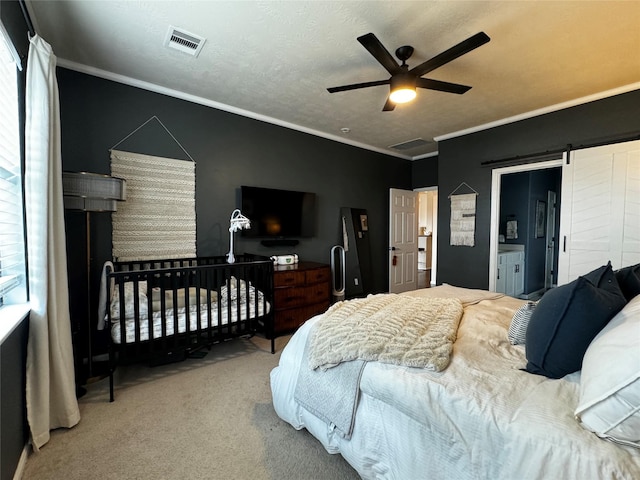 bedroom featuring crown molding, carpet, a textured ceiling, a barn door, and multiple windows