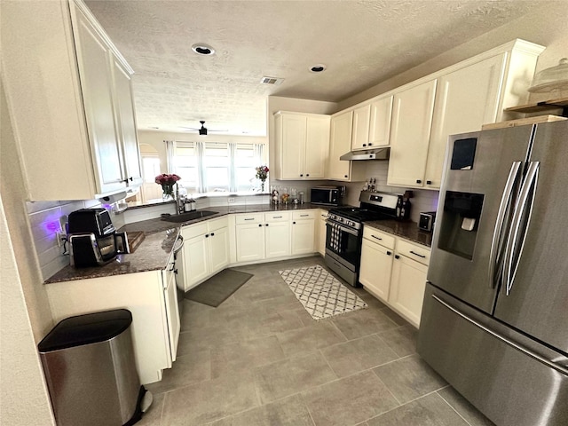 kitchen featuring stainless steel appliances, white cabinetry, sink, and a textured ceiling