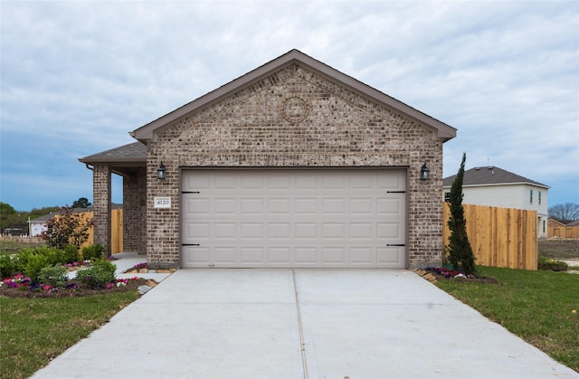 view of front of property featuring a garage and a front yard