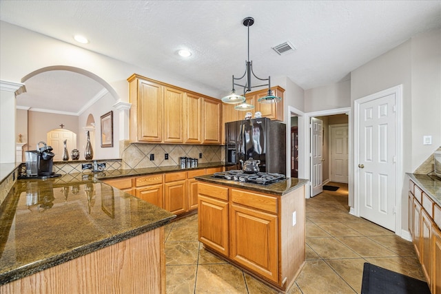 kitchen with kitchen peninsula, a center island, black appliances, decorative backsplash, and pendant lighting