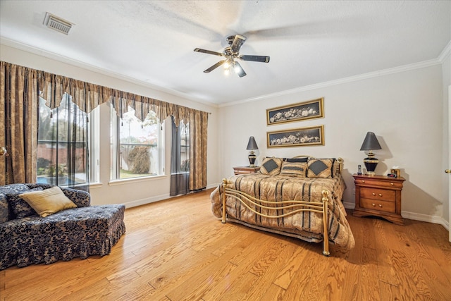 bedroom featuring ceiling fan, ornamental molding, and light hardwood / wood-style flooring