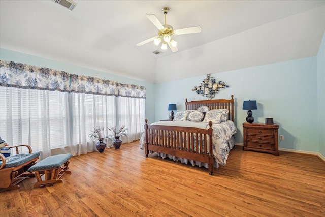 bedroom with ceiling fan, light wood-type flooring, and vaulted ceiling