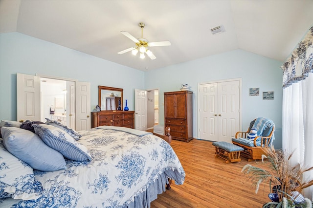 bedroom with ceiling fan, lofted ceiling, light hardwood / wood-style floors, and a closet