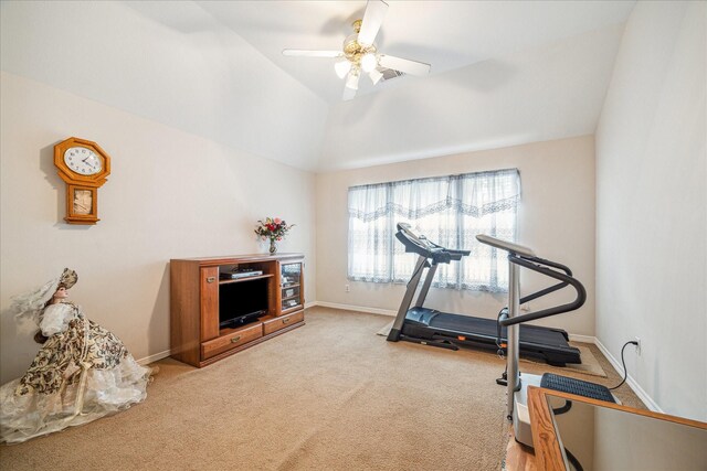 workout room with ceiling fan, carpet flooring, and vaulted ceiling