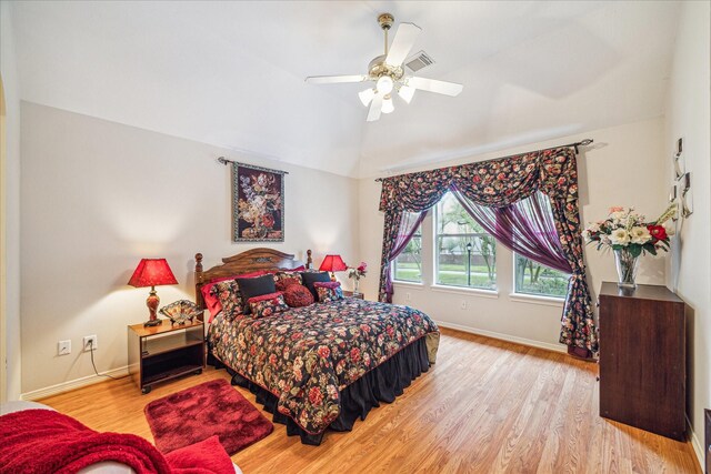 bedroom featuring ceiling fan, lofted ceiling, and light hardwood / wood-style floors