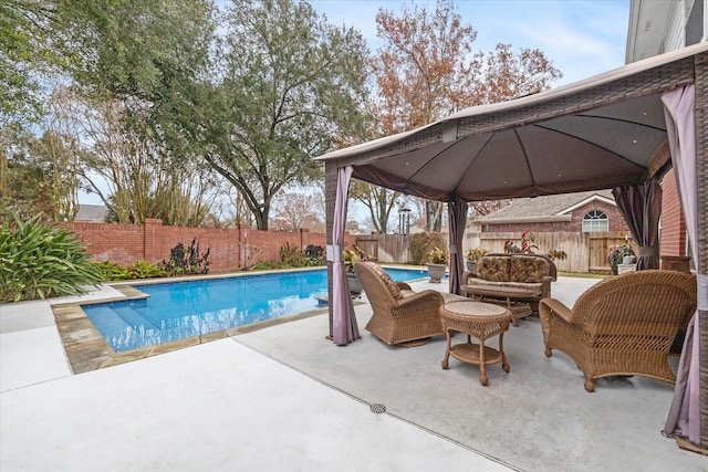 view of swimming pool featuring outdoor lounge area, a patio, and a gazebo