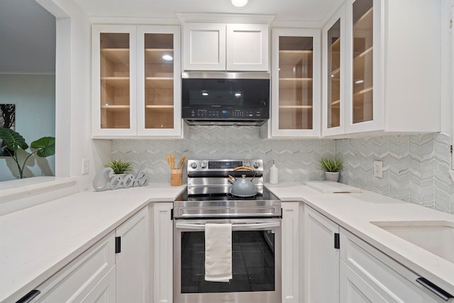 kitchen featuring stainless steel appliances, sink, decorative backsplash, and white cabinets