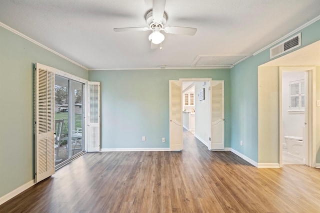 empty room with hardwood / wood-style flooring, ceiling fan, and ornamental molding