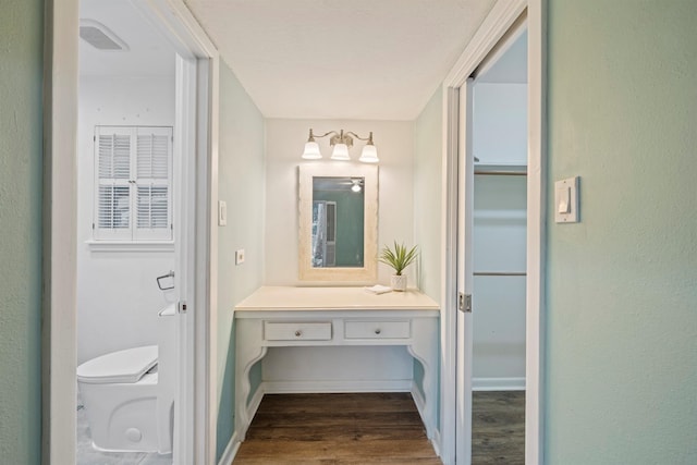 bathroom with vanity, toilet, and hardwood / wood-style floors