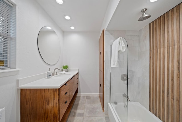 bathroom featuring vanity and tiled shower / bath