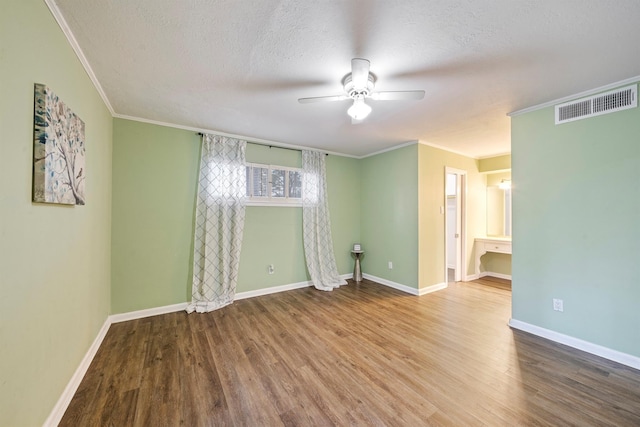 unfurnished room with hardwood / wood-style flooring, ornamental molding, ceiling fan, and a textured ceiling