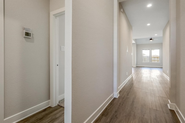 hall with recessed lighting, baseboards, and dark wood-style flooring