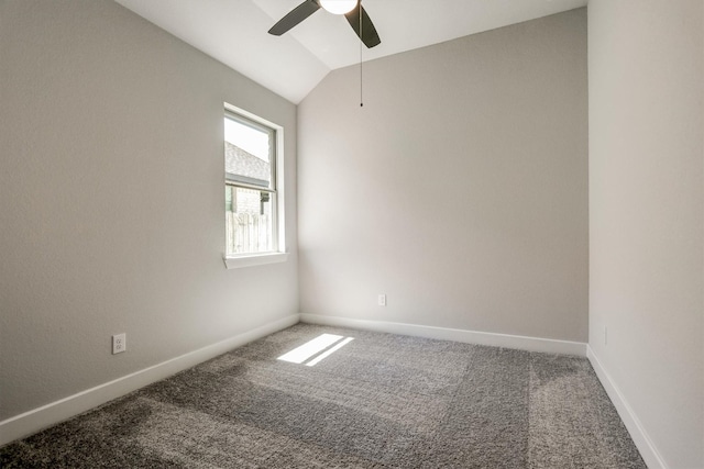 carpeted spare room with ceiling fan, baseboards, and vaulted ceiling