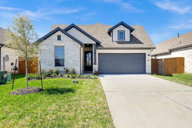 view of front facade with driveway, fence, a front yard, a shingled roof, and a garage