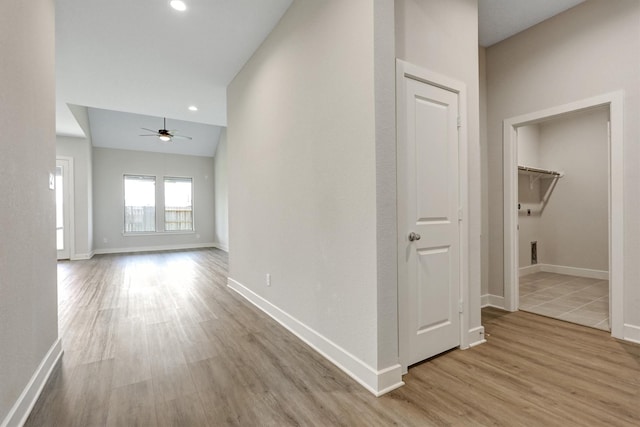 corridor with recessed lighting, baseboards, and wood finished floors