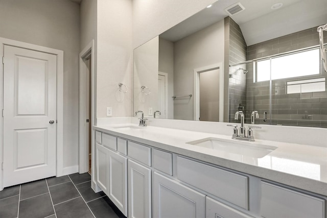 full bath with tile patterned floors, visible vents, a shower stall, and a sink