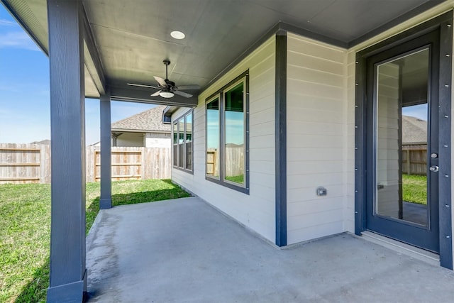 view of patio with ceiling fan and fence