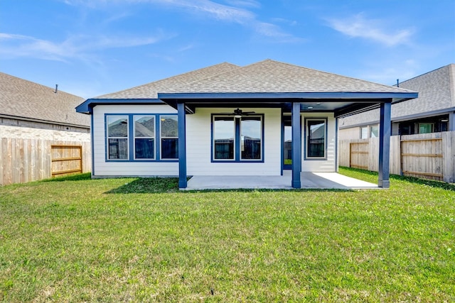 back of property featuring a fenced backyard, ceiling fan, a shingled roof, a patio area, and a lawn