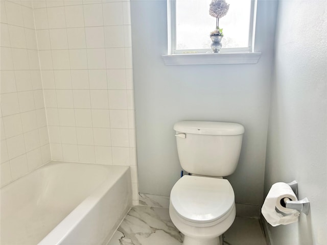 bathroom with washtub / shower combination and toilet