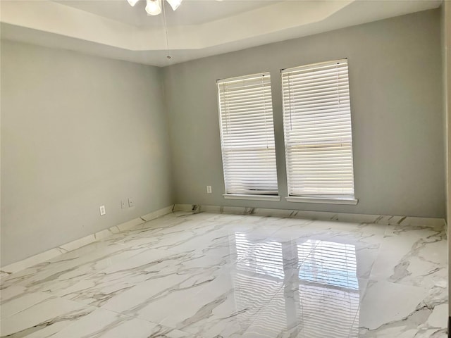 unfurnished room with a raised ceiling