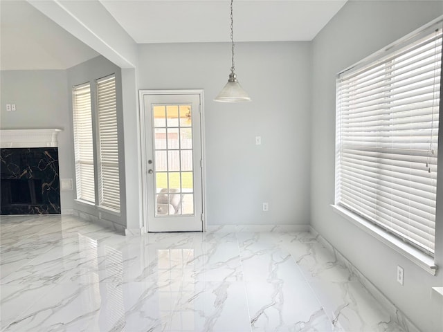 unfurnished dining area featuring a premium fireplace