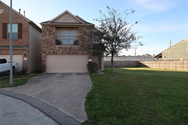 view of property featuring a garage, a balcony, and a front yard