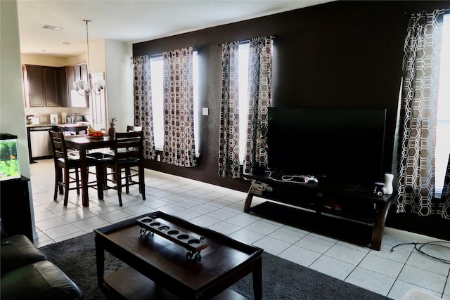 tiled living room featuring a chandelier