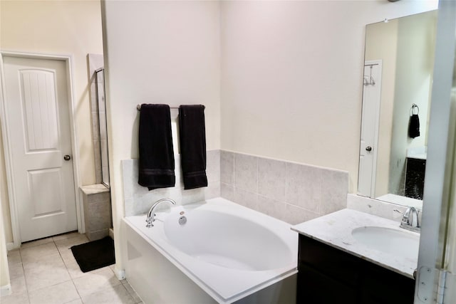 bathroom with vanity, tile patterned floors, and a tub