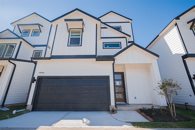 view of front of property featuring board and batten siding, driveway, and a garage