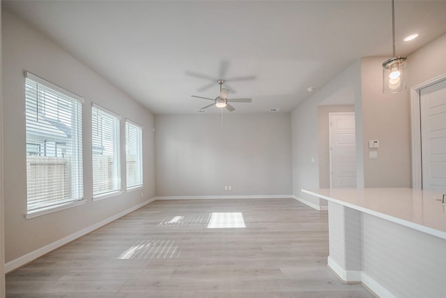 unfurnished room with light wood-style flooring, baseboards, ceiling fan, and recessed lighting