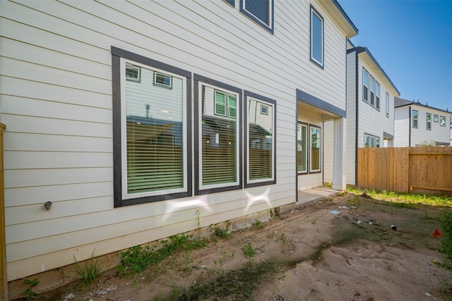 view of home's exterior with fence