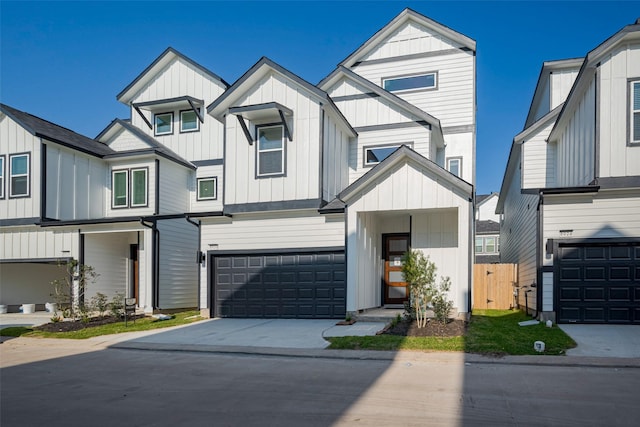 view of front of property with board and batten siding, concrete driveway, and an attached garage