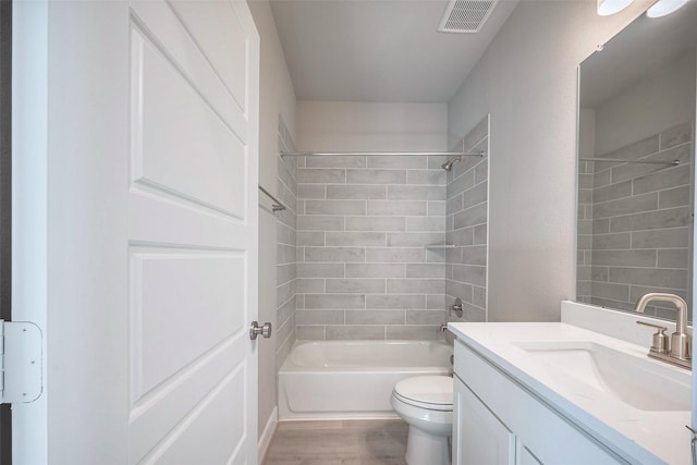 full bathroom featuring visible vents, toilet, wood finished floors,  shower combination, and vanity