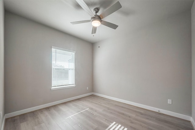 unfurnished room with ceiling fan, light wood-style flooring, and baseboards