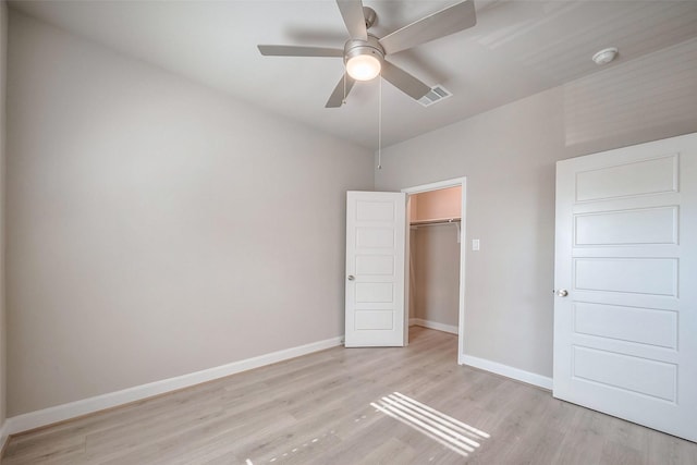 unfurnished bedroom featuring a closet, light wood-type flooring, visible vents, and baseboards