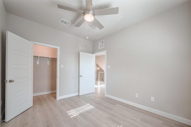 unfurnished bedroom featuring a closet, visible vents, light wood-style flooring, and baseboards