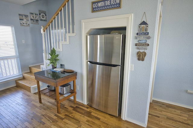 kitchen with dark wood-type flooring and stainless steel fridge