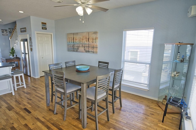 dining area with hardwood / wood-style flooring and ceiling fan