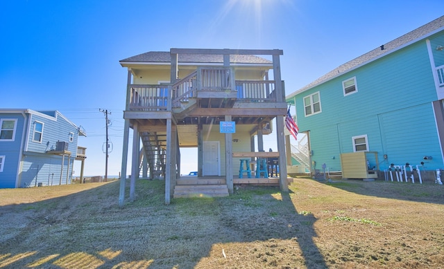 back of property featuring a deck and a lawn