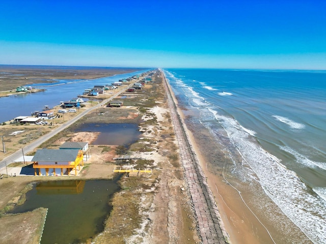 aerial view with a water view and a beach view