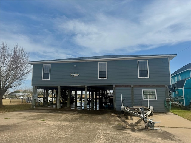 back of property with a carport