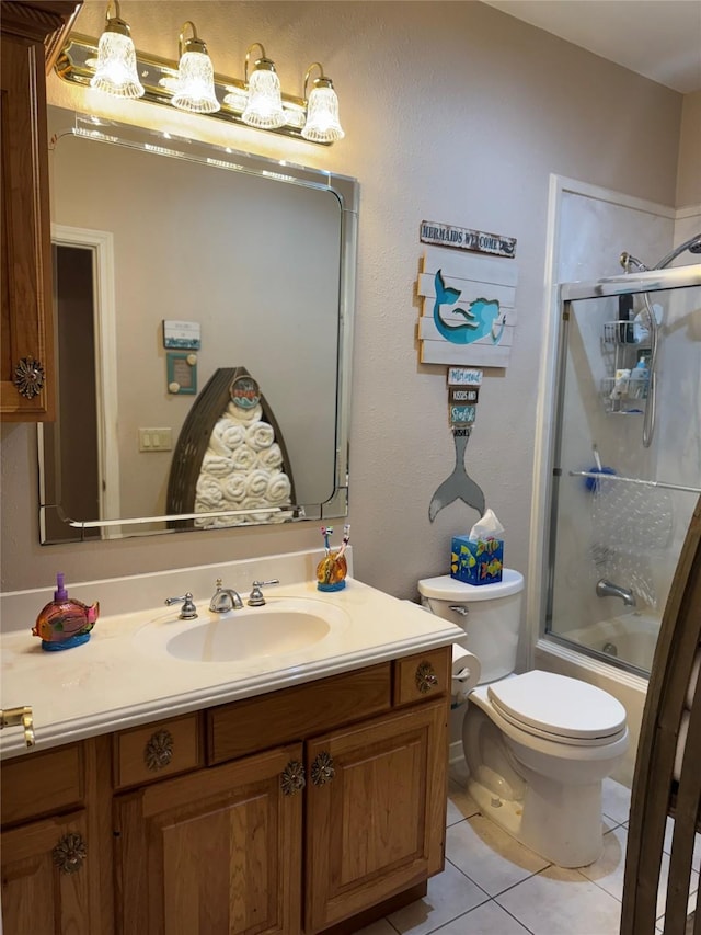 full bathroom with toilet, tile patterned floors, bath / shower combo with glass door, and vanity