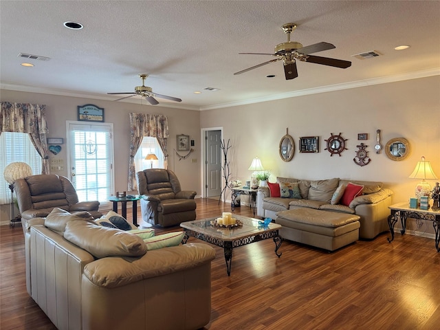 living room featuring ornamental molding, dark hardwood / wood-style floors, and a textured ceiling