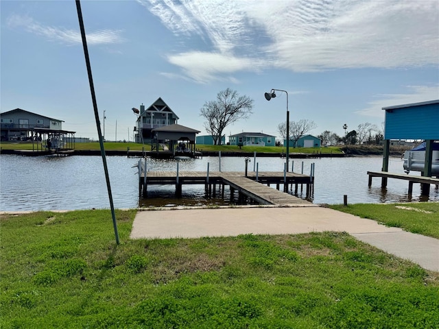 dock area with a lawn and a water view